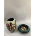 A Moorcroft vase, Dahlia pattern, ovoid, tubelined and painted in deep reds, purple and green on a