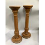 Pair of pine turned columns on a stepped base with flat top 63cm high