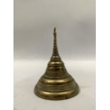 A brass model of a Buddhist stupa with concentric bands, 9cm high
