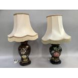 A pair of ceramic lamps with over painted flowers in brown and metallic green glaze, on wooden