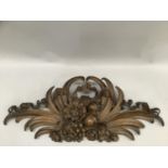 A heavily carved fruitwood pediment formed as the branch of fruit with acanthus leaves and flowers