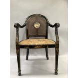 An ebonised chinoiserie carver chair with caned seat and original cane back with central cartouche