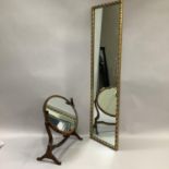 An oval mahogany dressing table mirror together with gilt wall mirror with moulded foliate frame,