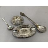 A silver gilt and enamelled commemorative spoon, a silver circular ashtray and a plated oval ashtray