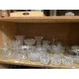 Large quantity of cut glass comprising vases, trifle bowls, tulip vases, lidded bon bon dish, etc.