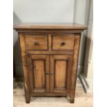 A modern hard wood pot cupboard with two short drawers above cupboard doors opening to reveal