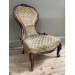 19th century mahogany nursing chair with carved foliate crest and frame on cabriole legs upholstered