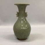 A Chinese celadon glaze twin handled vase, the body etched with bamboo and flowers with flared