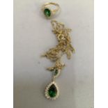 A suite of cluster ring and pendant both set with green and simulated gem stones in yellow metal (