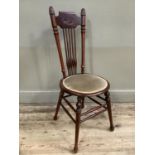 A spindle back side chair, the upper frame carved with crest, on turned legs with stretcher supports