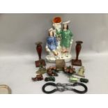 A pair of lacquer and overpainted red candlesticks, a brass letter stand, brass letter holder,