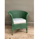 A green painted Lloyd Loom style wicker chair with upholstered white seat