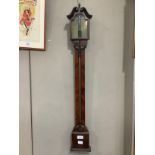 A mahogany Georgian barometer with separated pediment and brass urn finial, the base featuring a