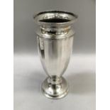 A silver vase of panelled and tapered form on a circular stepped and weighted base, 18cm high,