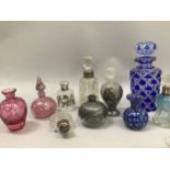 Quantity of scent bottles of varying sizes including Bohemian and cranberry examples, together