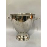 A white metal ice bucket on stepped foot with twin moulded handles and beaded rim 34cm high