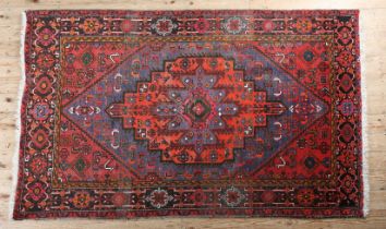 A MIDDLE EASTERN RUG, the mid blue field with a deep coral stepped lozenge, filled with geometric