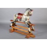 A MID 20th CENTURY ROCKING HORSE IN THE STYLE OF COLLINSON having black and white dappled body