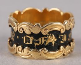 A WILLIAM IV MOURNING RING in 18ct gold, 'in memory of' in gold gothic letters raised against a