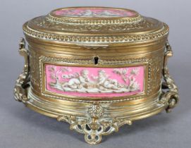 A FRENCH TAHAN 19TH CENTURY ORMOLU AND ENAMEL CASKET of oval form, having enamel panels depicting