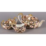 A ROYAL CROWN DERBY IMARI TEA SERVICE comprising teapot and milk jug dated 1909 and twin handled