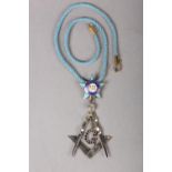 A MASONIC MASTERS JEWEL in sapphire set silver, the square and compass with pendant stone set G