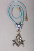 A MASONIC MASTERS JEWEL in sapphire set silver, the square and compass with pendant stone set G