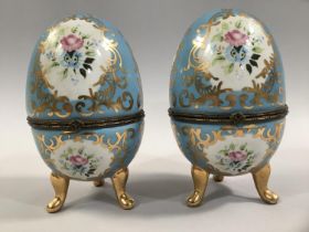 A PAIR OF FRENCH PORCELAIN CASKETS, ovoid decorated in the Sevres style, with floral and gilt