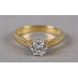 A SINGLE STONE DIAMOND RING in 18ct yellow and white gold, the brilliant cut stone crown set,