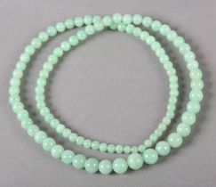 A JADE NECKLACE OF GRADUATED SPHERICAL BEADS, without fastener and strung on a later line,