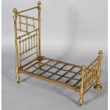 A VICTORIAN DOLL'S BRASS AND IRON HALF-TESTER BED with wide brass knob finials (at fault), 73cm high