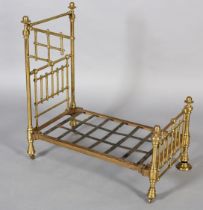 A VICTORIAN DOLL'S BRASS AND IRON HALF-TESTER BED with wide brass knob finials (at fault), 73cm high