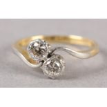 A TWO STONE DIAMOND RING C1950 in 18ct gold and platinum, the brilliant cut stones illusion set in a