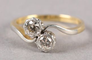 A TWO STONE DIAMOND RING C1950 in 18ct gold and platinum, the brilliant cut stones illusion set in a