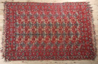 A MIDDLE EASTERN RUG, the flatweave field of camel colour with thin red stripe, filled with ten rows