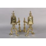 A PAIR OF AESTHETIC MOVEMENT BRASS FIRE DOGS, each with an arched panel worked with a robin