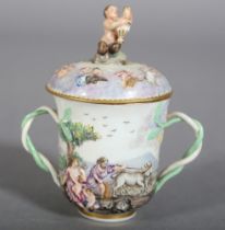 AN ITALIAN PORCELAIN CUP AND COVER moulded and enamelled in the Naples manner with classical figures