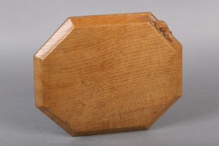 A THOMPSON OF KILBURN 'MOUSEMAN' OAK BREAD OR CHEESE BOARD, of irregular octagonal form, the