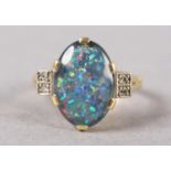 AN BLACK OPAL DOUBLET AND DIAMOND RING C1950 in 18ct gold, the oval cabochon stone claw set