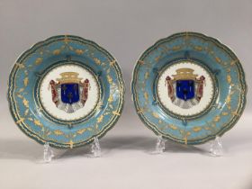 A PAIR 19TH CENTURY SEVRES PORCELAIN CABINET PLATES central armorial motif, bordered with blue