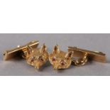 A PAIR OF GEORGE V FOX MASK CUFFLINKS in 18ct gold, each half relief engraved mask set with ruby