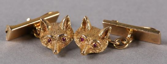 A PAIR OF GEORGE V FOX MASK CUFFLINKS in 18ct gold, each half relief engraved mask set with ruby