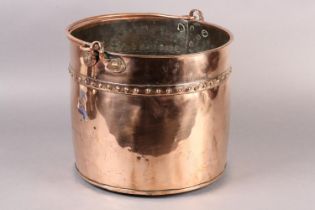 AN EARLY 20TH CENTURY COPPER LOG BUCKET, cylindrical with swing handle and studded seams, 34cm