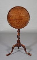 A GEORGE III MAHOGANY TILT TOP TABLE, dished circular top on a wrythen turned vase column on a