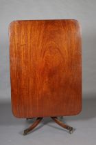 AN EARLY 19TH CENTURY MAHOGANY BREAKFAST TABLE having a rectangular tilt top with rounded corners,