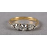 A FIVE STONE DIAMOND RING C1950 in 18ct gold and platinum, the graduated transitional brilliant