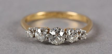 A FIVE STONE DIAMOND RING C1950 in 18ct gold and platinum, the graduated transitional brilliant