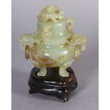 A CHINESE CARVED HARDSTONE INCENSE BURNER AND COVER OF PALE GREEN COLOUR, the domed cover with