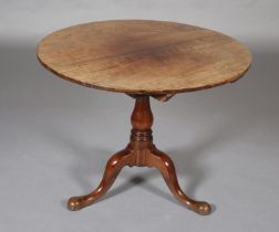 A GEORGE III MAHOGANY 'BIRDCAGE' TRIPOD TABLE, having a circular tilt top on a vase turned column