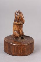 A THOMPSON OF KILBURN 'MOUSEMAN' OAK CARVING OF A MOUSE, standing on its haunches, raised on a